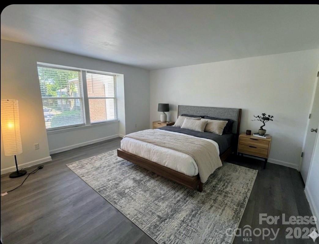 9333 Old Concord Road, Unit J Charlotte, NC 28213 - Photo 8 of 18 a bedroom with a bed and wooden floor