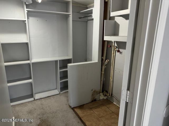 5332 Colonial Avenue Jacksonville, FL 32210 - Photo 13 of 15 a view of walk in closet with clothes and shoes