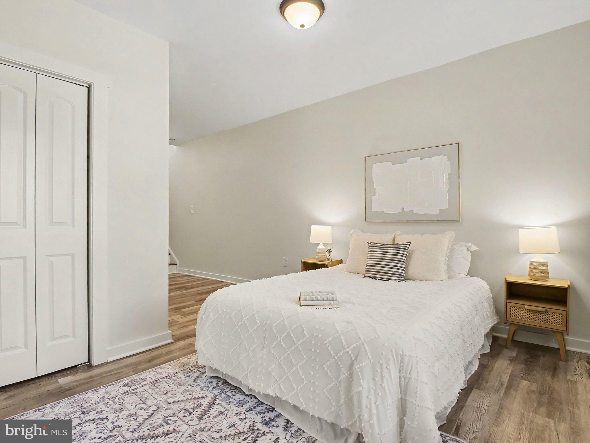 3915 Roland Avenue Baltimore, MD 21211 - Photo 21 of 26 a bedroom with a bed and a lamp