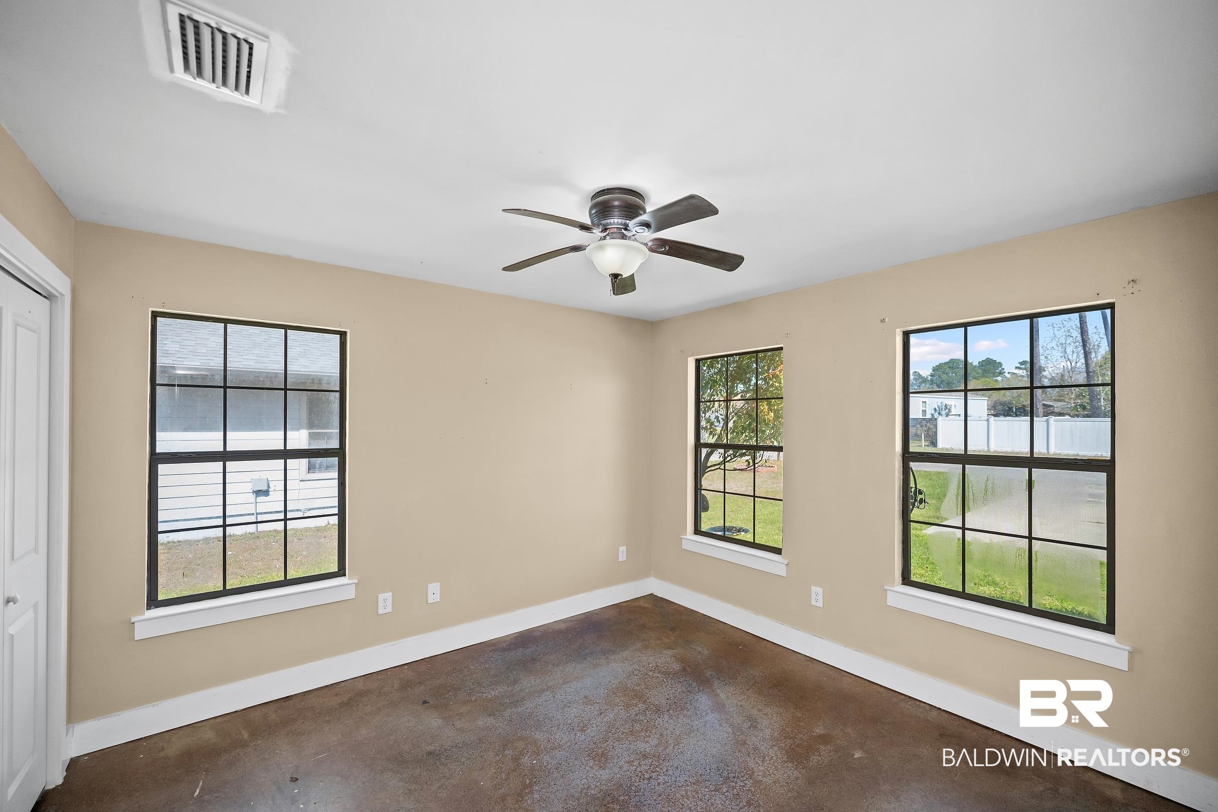 2000 Maria Lane Lillian, AL 36549 - Photo 9 of 35 Empty room with finished concrete flooring and a ceiling fan