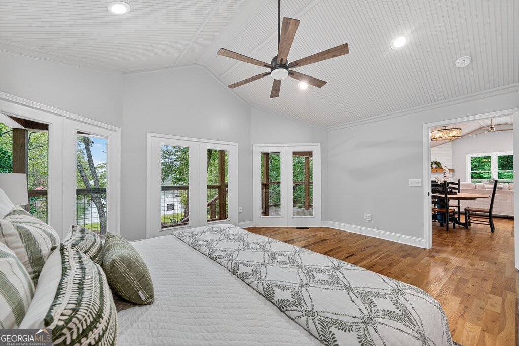 291 Power Point Milledgeville, GA 31061 - Photo 31 of 51 a spacious bedroom with a large bed and a chandelier