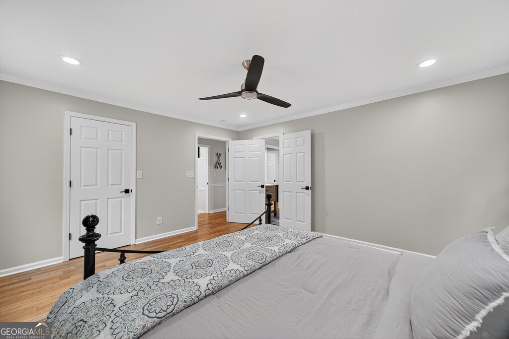 291 Power Point Milledgeville, GA 31061 - Photo 38 of 51 a bedroom with a bed and a chandelier