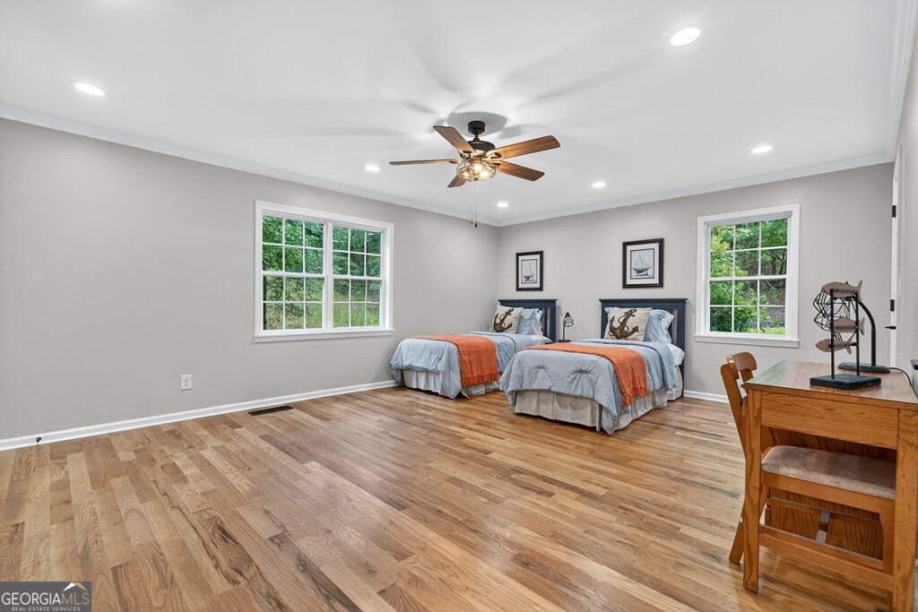 291 Power Point Milledgeville, GA 31061 - Photo 42 of 51 a spacious bedroom with a bed and a table with chair