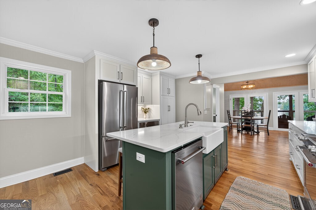 291 Power Point Milledgeville, GA 31061 - Photo 9 of 51 a dining hall with stainless steel appliances granite countertop a kitchen island a stove and a wooden floors