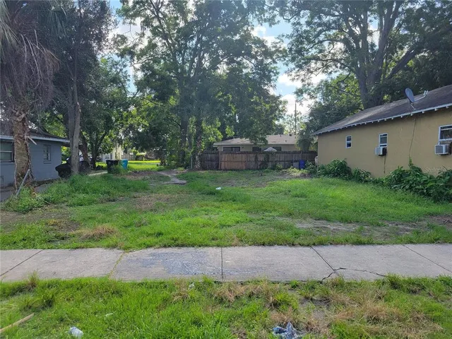 a view of a backyard with a garden and trees
