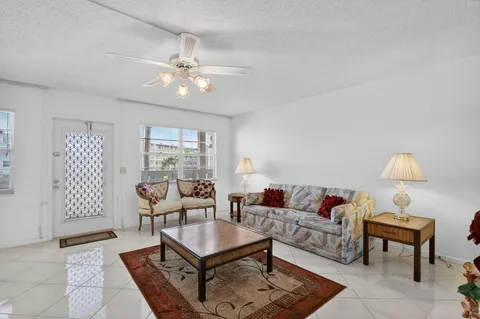 a living room with furniture a lamp and a window