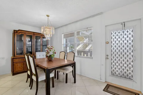 a view of a dining room with furniture and chandelier