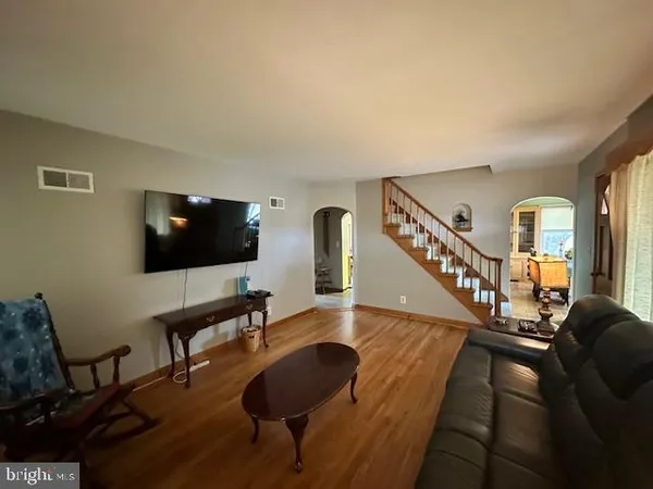 a living room with furniture and a flat screen tv