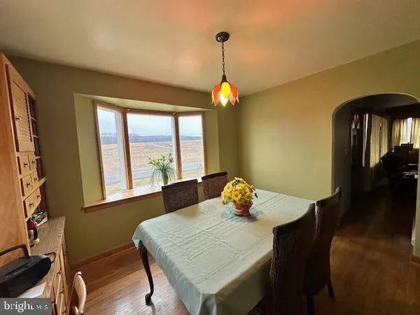 a view of a dining room with a table and chairs