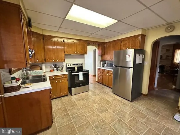 a kitchen with refrigerator and cabinets