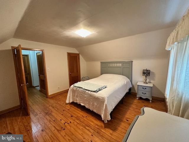 19642 Raystown Road James Creek, PA 16657 - Photo 28 of 38 a bedroom with a bed and wooden floor