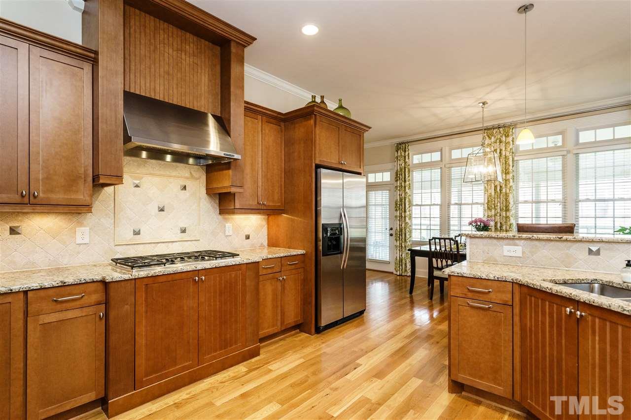 2000 Angelwing Court Raleigh, NC 27613 - Photo 12 of 25 a kitchen with stainless steel appliances granite countertop a sink stove and refrigerator