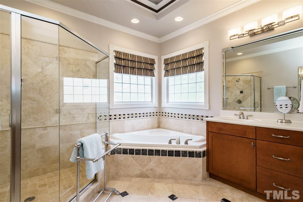 2000 Angelwing Court Raleigh, NC 27613 - Photo 16 of 25 a bathroom with a tub sink and mirror