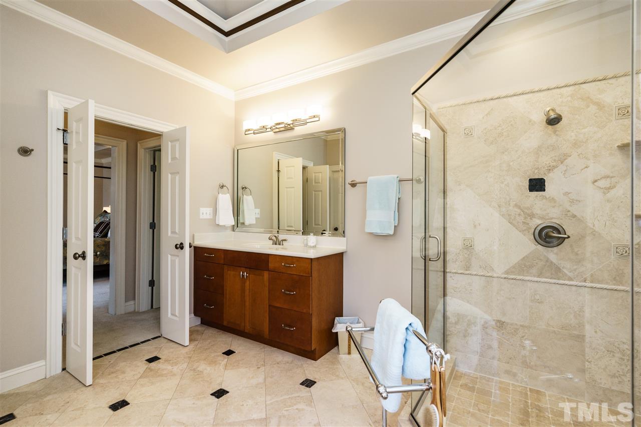2000 Angelwing Court Raleigh, NC 27613 - Photo 17 of 25 a spacious bathroom with a shower sink and mirror