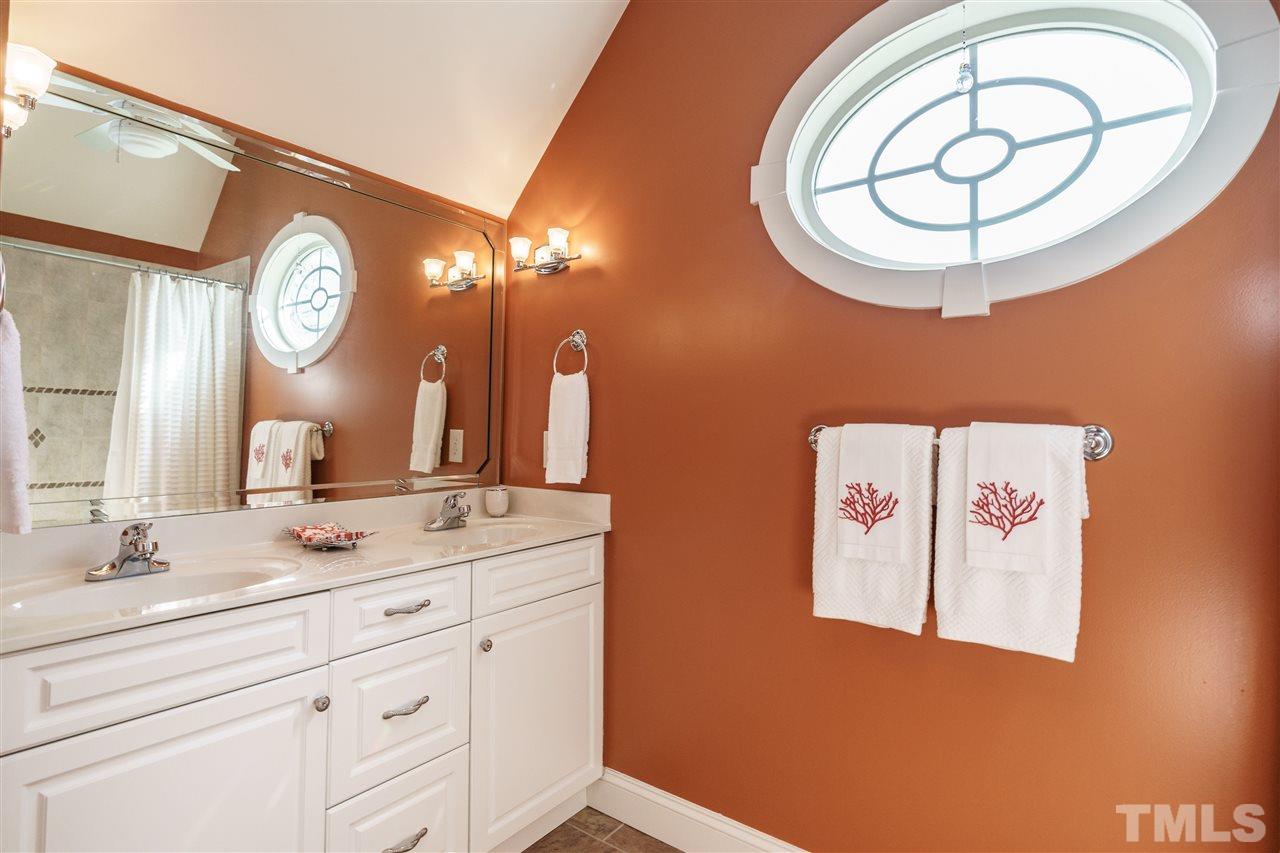2000 Angelwing Court Raleigh, NC 27613 - Photo 19 of 25 a bathroom with a sink and a mirror
