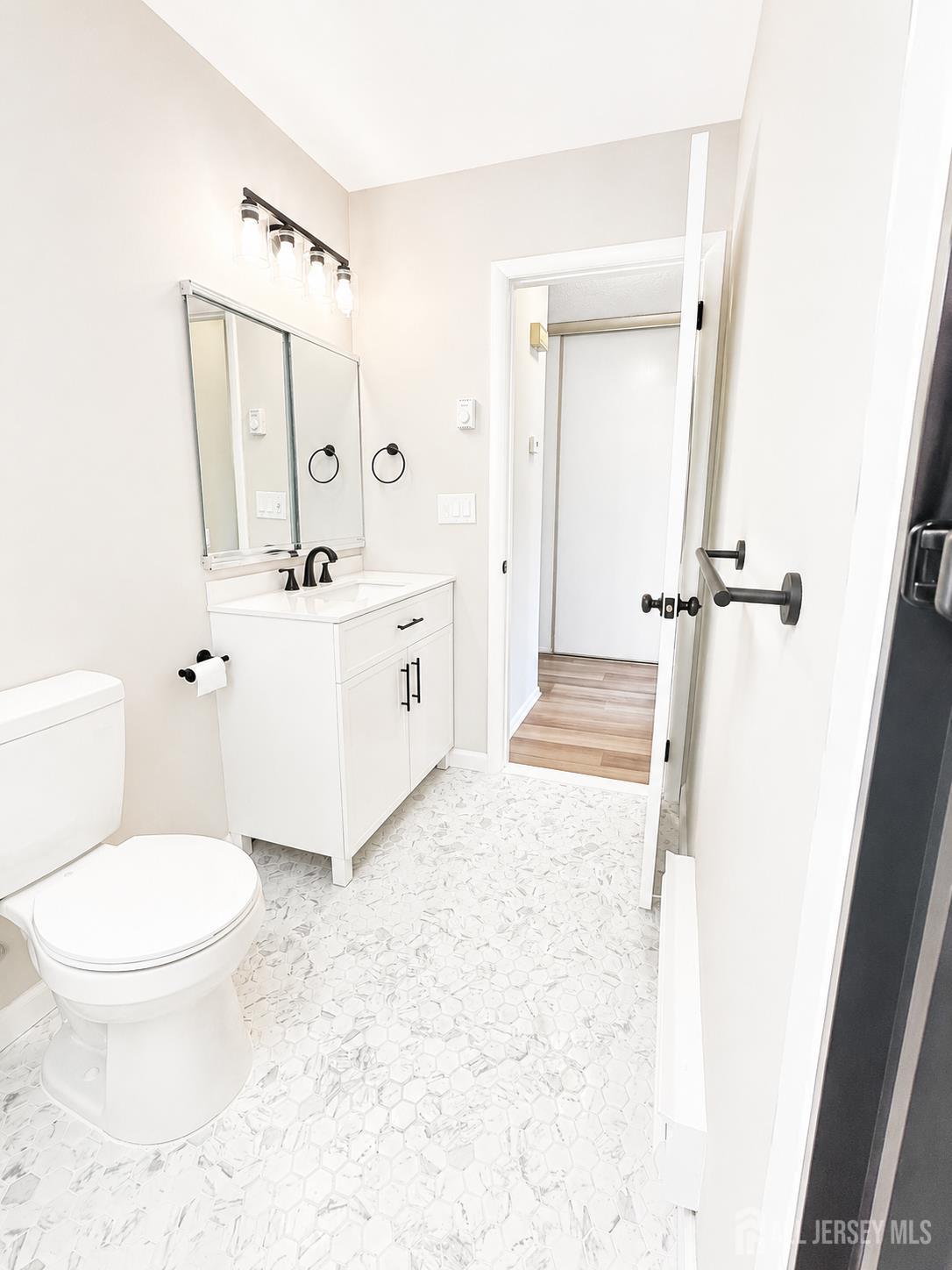 621 A Deal Road Monroe Township, NJ 08831 - Photo 16 of 27 a bathroom with a sink a toilet and shower