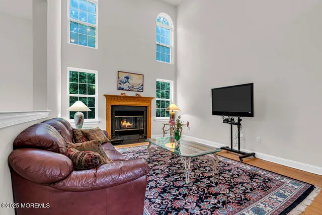 a living room with furniture a window and a fireplace