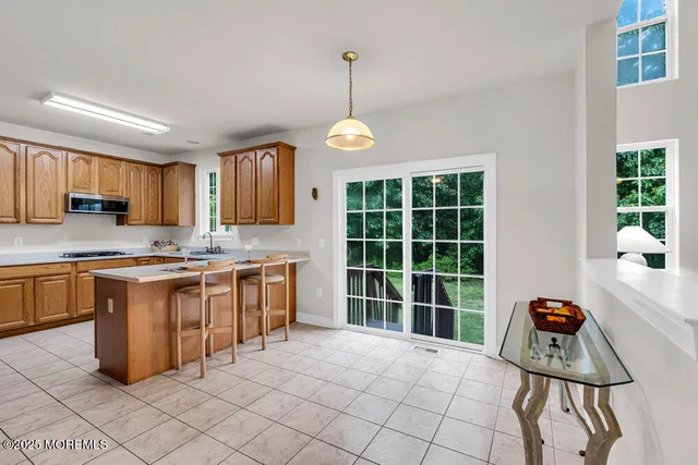 a kitchen with stainless steel appliances granite countertop a stove top oven a sink dishwasher and cabinets with wooden floor