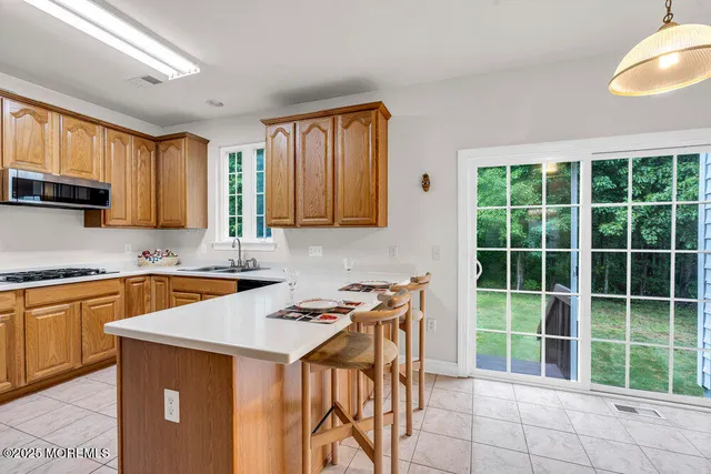 a kitchen that has a sink a stove and a wooden cabinets