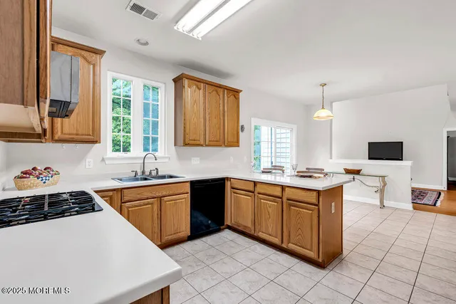 a kitchen with stainless steel appliances a sink stove and cabinets