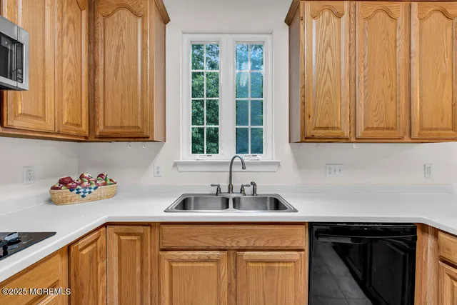 a kitchen with stainless steel appliances granite countertop a sink a refrigerator and cabinets