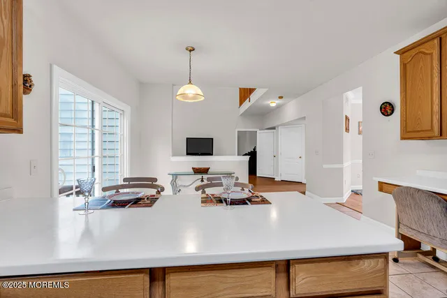a view of kitchen island with stainless steel appliances granite countertop sink and window