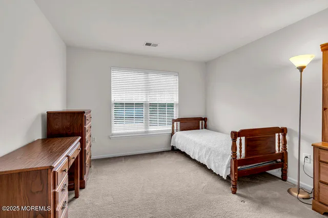 a bed room with a bed and a chair