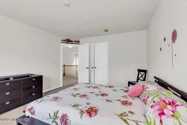 a view of a hallway with wooden floor and windows