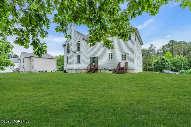 a view of a grassy field with trees