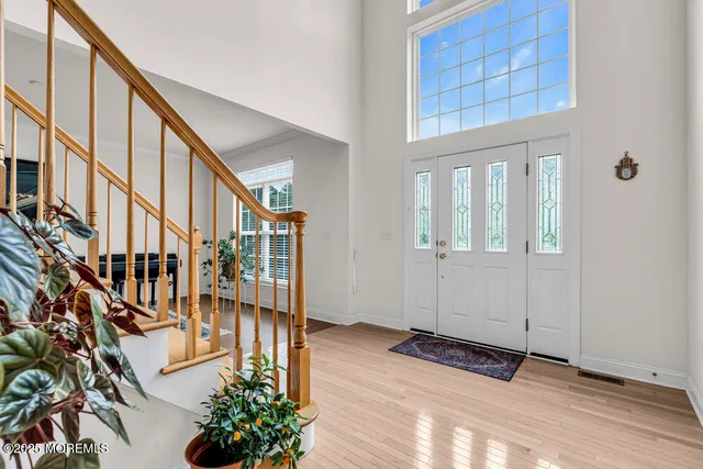 a view of an entryway with wooden floor and door