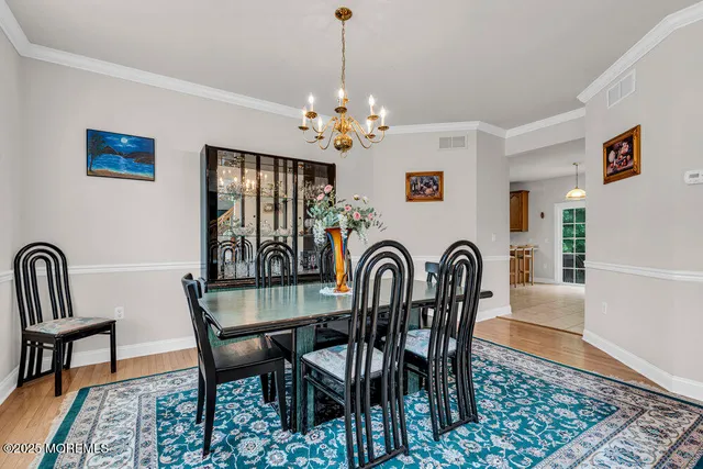 a view of a dining room and hall with furniture