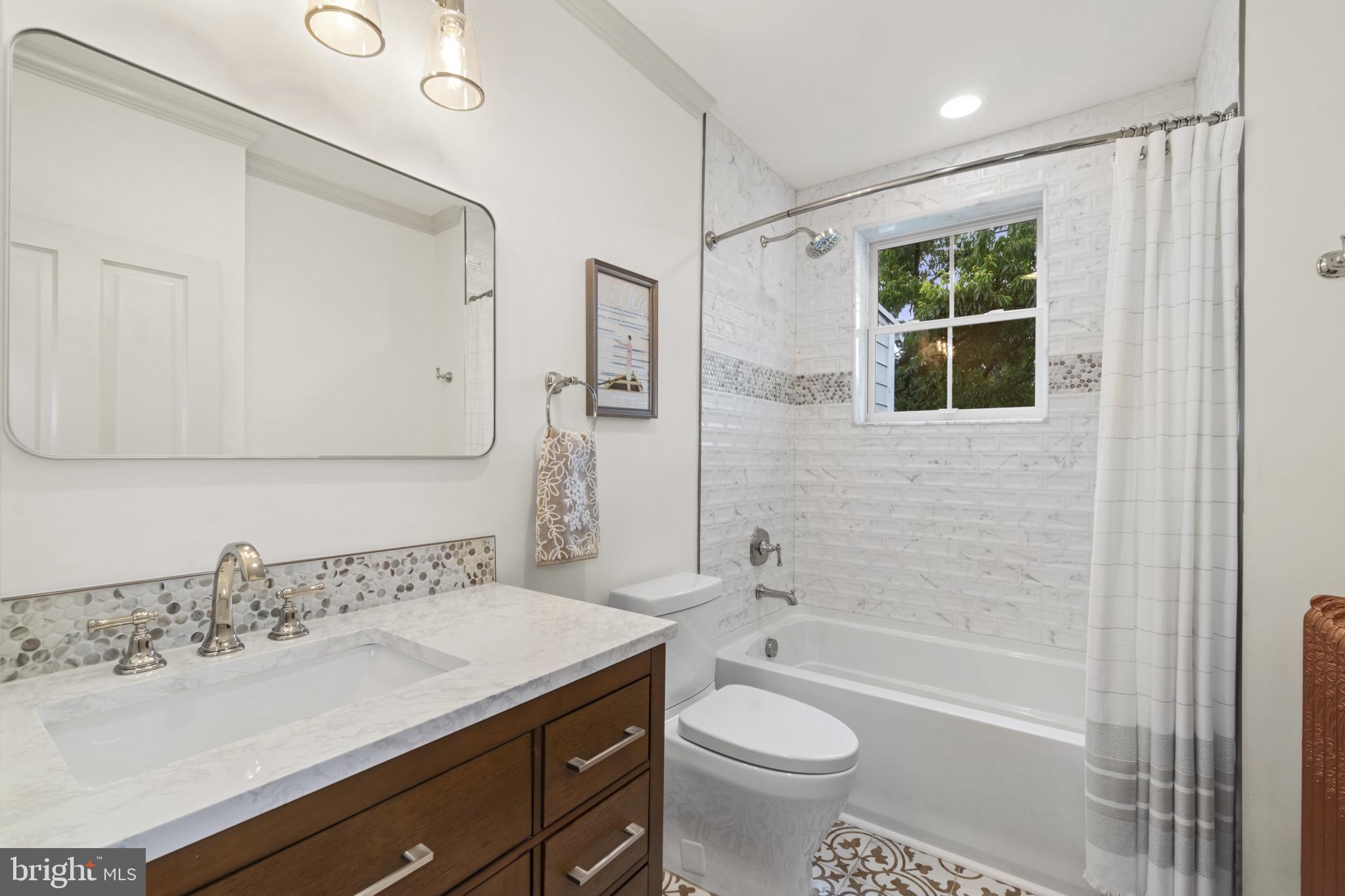 4300 Evans Chapel Road Baltimore, MD 21211 - Photo 23 of 40 a bathroom with a granite countertop sink a toilet and shower