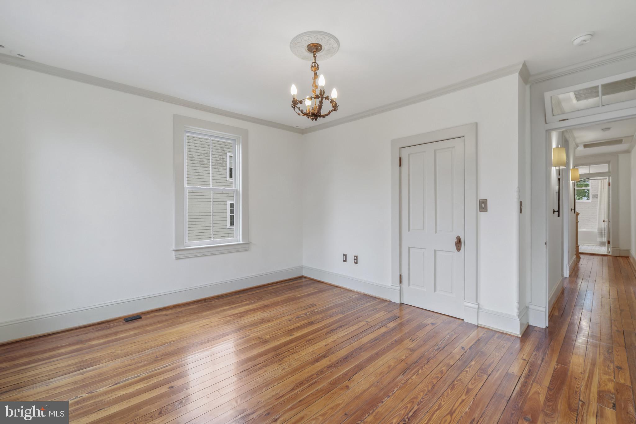 4300 Evans Chapel Road Baltimore, MD 21211 - Photo 26 of 40 a view of an empty room with wooden floor and a window