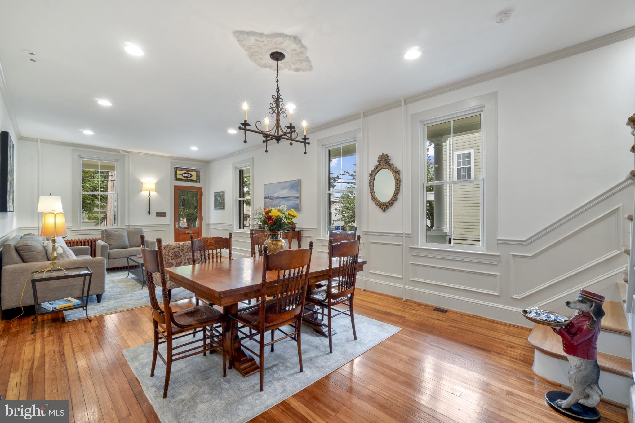 4300 Evans Chapel Road Baltimore, MD 21211 - Photo 7 of 40 a view of a dining room with furniture a chandelier and wooden floor