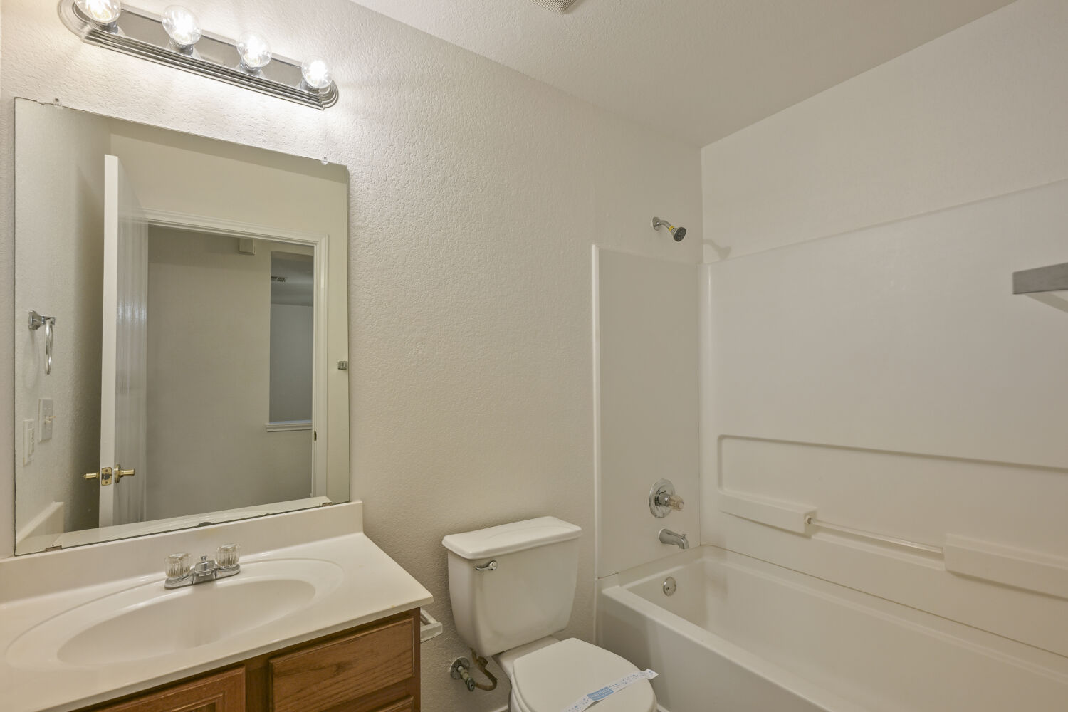 6733 Doyal Drive Austin, TX 78747 - Photo 22 of 28 A well-appointed bathroom offers a clean tub, vanity with sink, and mirror for daily routines.