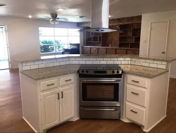 a kitchen with stainless steel appliances granite countertop a stove and a sink
