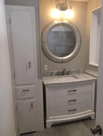 a bathroom with a sink and a mirror
