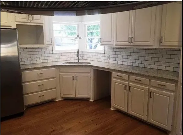 a kitchen with a sink cabinets and window