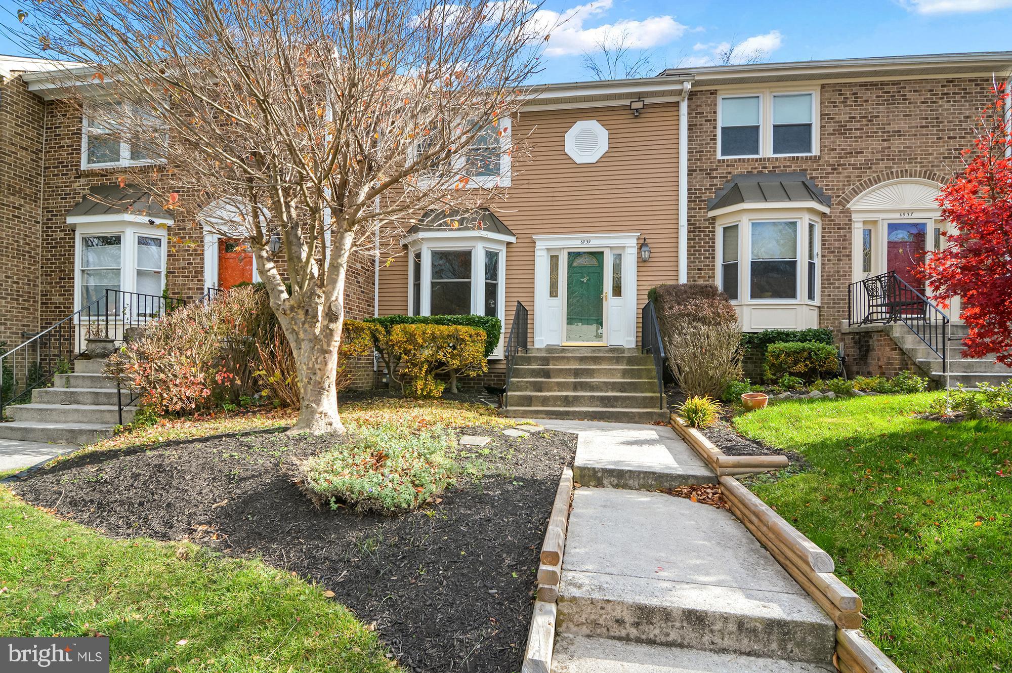 6939 Copper Bend Lane Baltimore, MD 21209 - Photo 1 of 18 a front view of a house with garden