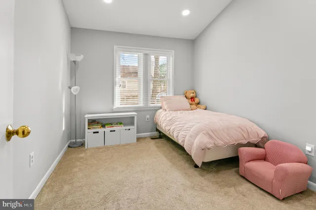 a bed room with a bed and a chair