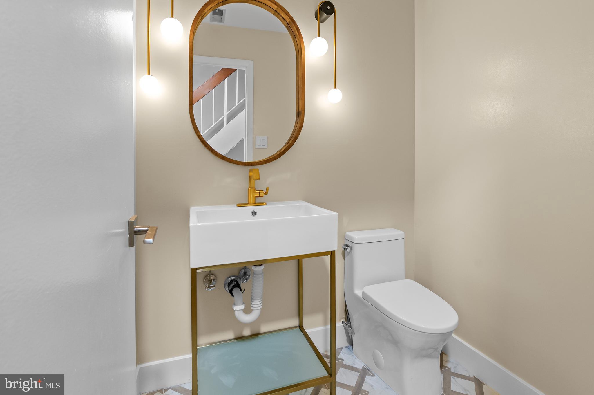 6939 Copper Bend Lane Baltimore, MD 21209 - Photo 8 of 18 a bathroom with a sink a mirror and a toilet