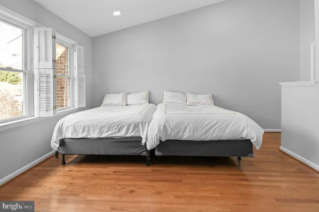 a bedroom with a bed a window and walk in closet