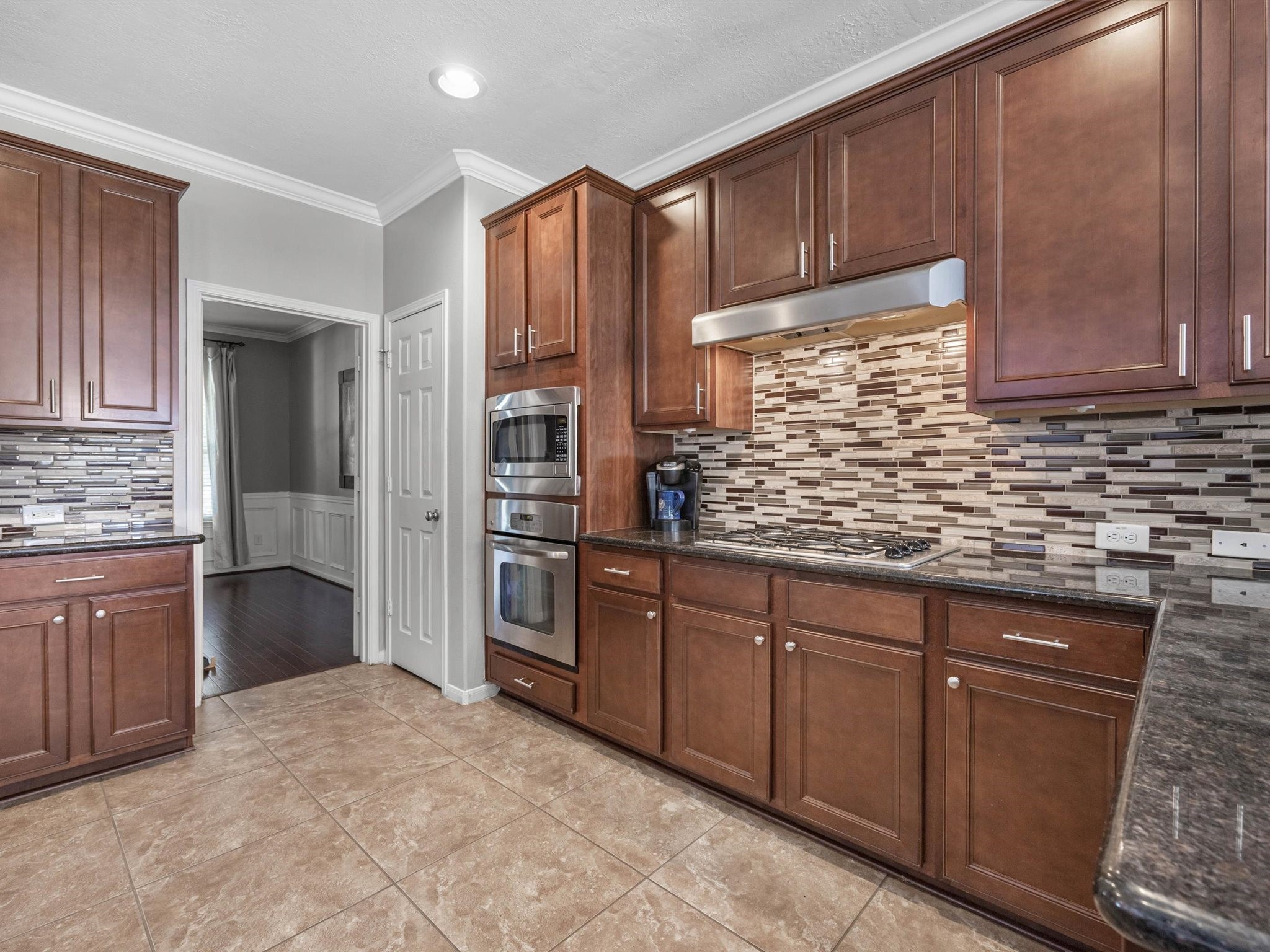 3310 Compass Court Conroe, TX 77301 - Photo 14 of 38 a kitchen with stainless steel appliances granite countertop cabinets and window