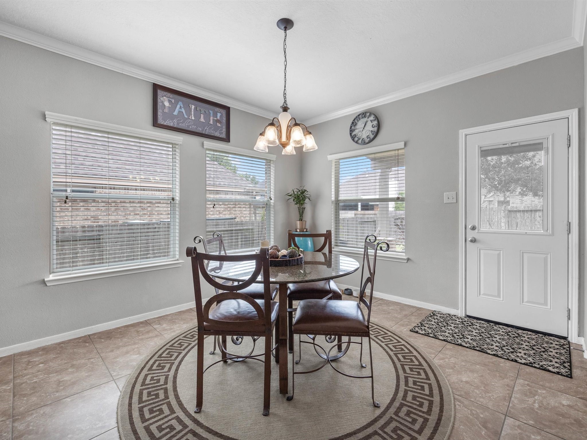 3310 Compass Court Conroe, TX 77301 - Photo 15 of 38 a dining room with furniture a chandelier and wooden floor