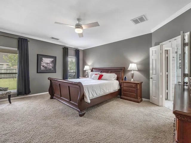 a bedroom with a large bed and a chandelier