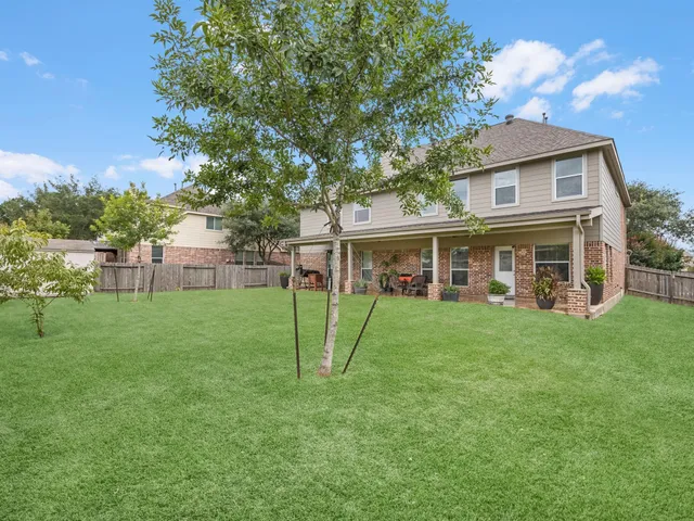 a view of a house with a backyard