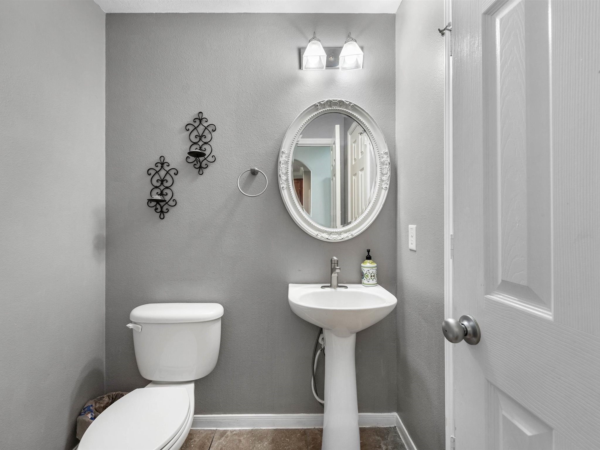 3310 Compass Court Conroe, TX 77301 - Photo 23 of 38 a bathroom with a toilet sink and mirror