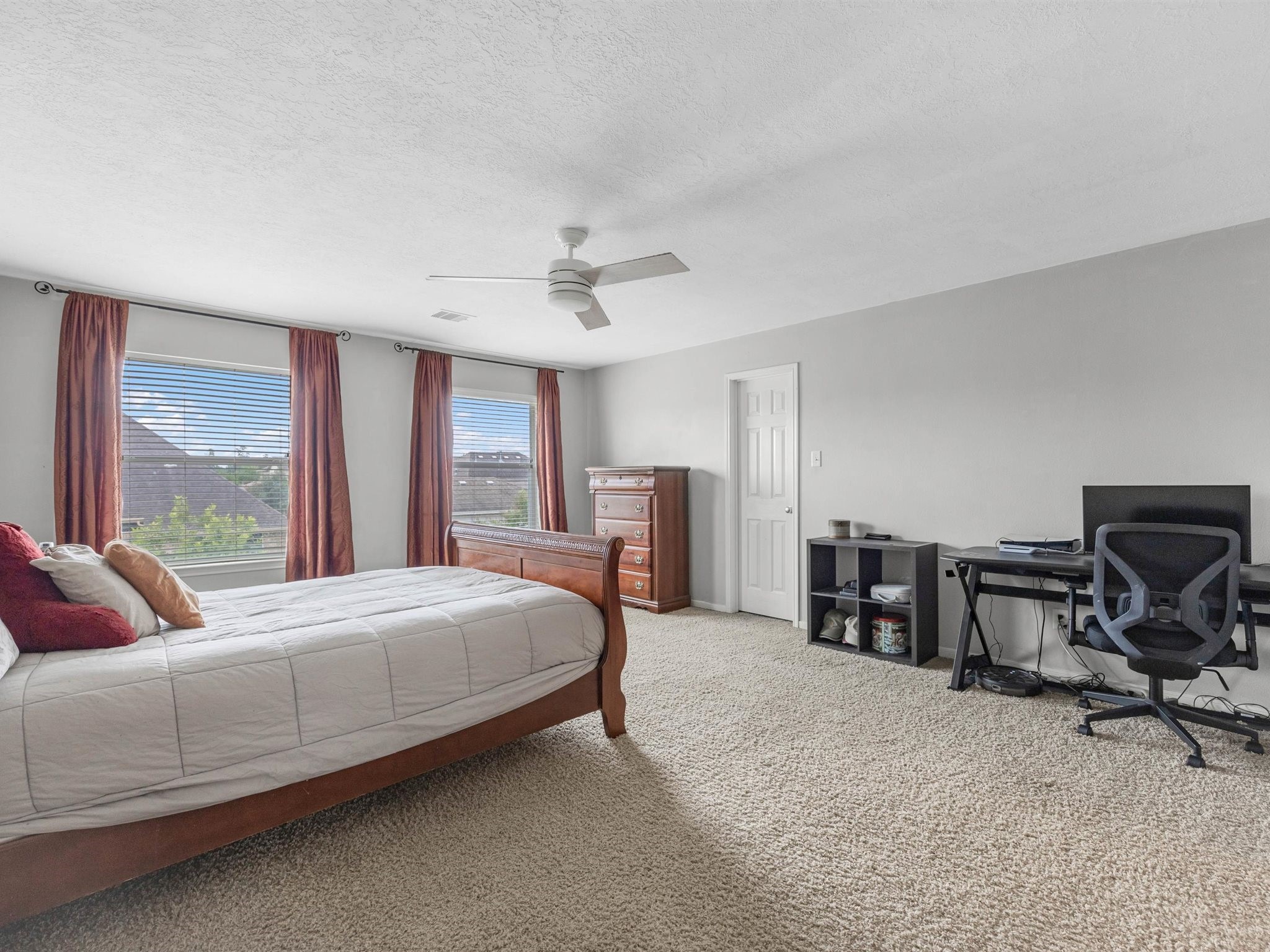 3310 Compass Court Conroe, TX 77301 - Photo 30 of 38 a bedroom with a bed a large window with table and chair