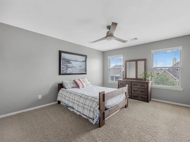 a bedroom with furniture and a large window