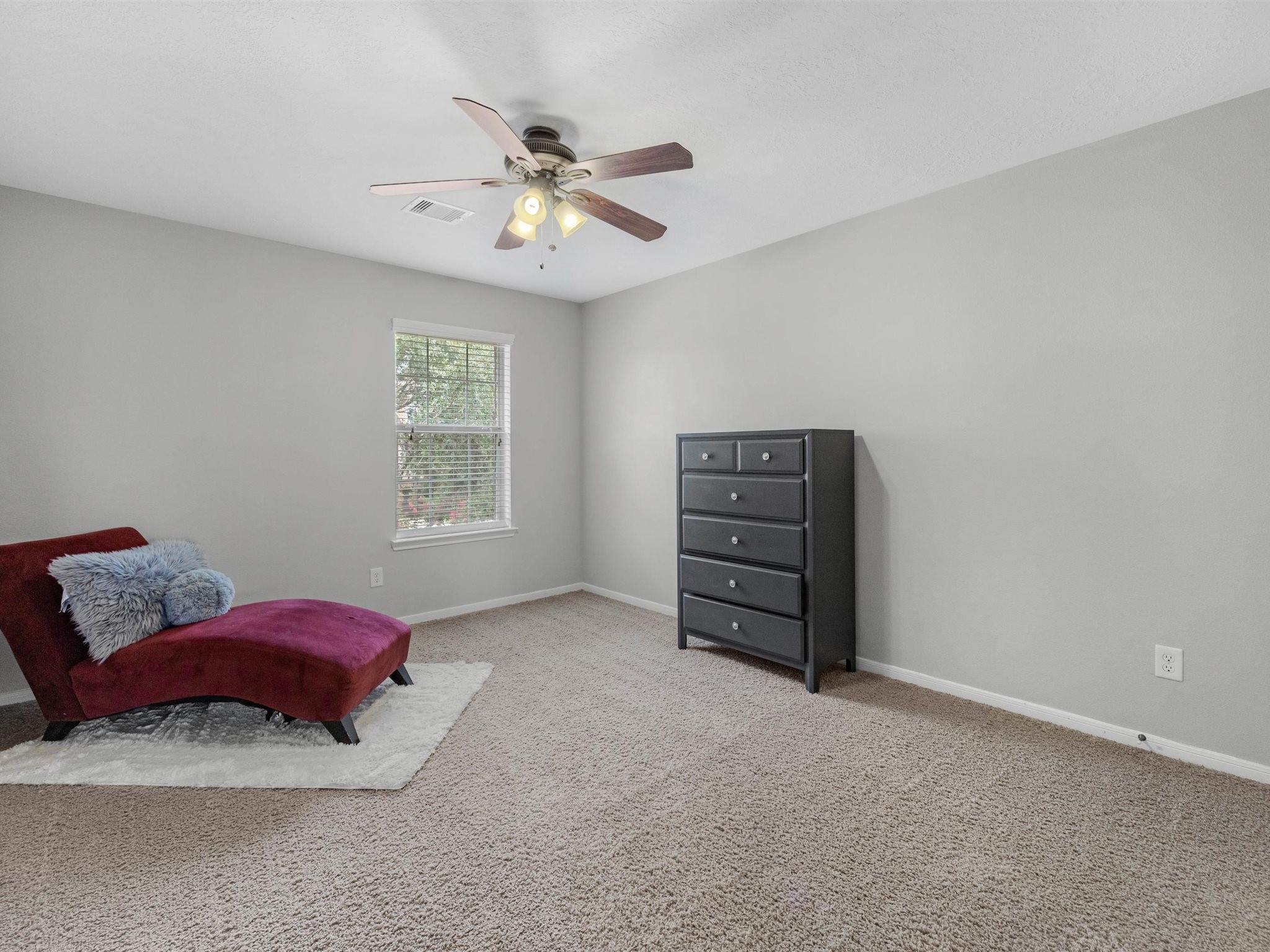 3310 Compass Court Conroe, TX 77301 - Photo 35 of 38 a bedroom with a bed and a chandelier